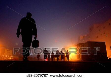 SAN DIEGO (Nov. 18, 2010) Sailors assigned to the amphibious assault ship USS Bonhomme Richard (LHD 6) walk through early morning fog to the ship and the messing and berthing barge. View Large Photo Image Stock Photo - SAN DIEGO (Nov. 18, 2010) Sailors assigned to the amphibious assault ship USS Bonhomme Richard (LHD 6) walk through early morning fog to the ship and the messing and berthing barge.. Fotosearch