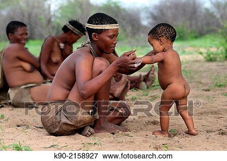 San mother with her kid excercising the first steps, Namibia, Africa. View Large Photo Image Stock Photo - San mother with her kid excercising the first steps, Namibia, Africa.. Fotosearch