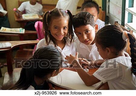 Stock Photograph - San Pedro, Belize - Students in a classroom at St Peter's Elementary School. Fotosearch