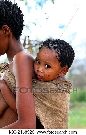 San woman carrying her baby on her back, Namibia, Africa. View Large Photo Image Stock Image - San woman carrying her baby on her back, Namibia, Africa.. Fotosearch