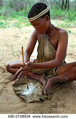 San woman drilling holes in small pieces of Ostrich eggs to form a necklace, Kalahari desert, Namibia, Africa. View Large Photo Image Picture - San woman drilling holes in small pieces of Ostrich eggs to form a necklace, Kalahari desert, Namibia, Africa.. Fotosearch