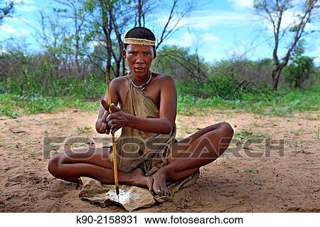 San woman drilling holes in small pieces of Ostrich eggs to form a necklace, Kalahari Desert, Namibia, Africa. View Large Photo Image Stock Image - San woman drilling holes in small pieces of Ostrich eggs to form a necklace, Kalahari Desert, Namibia, Africa.. Fotosearch