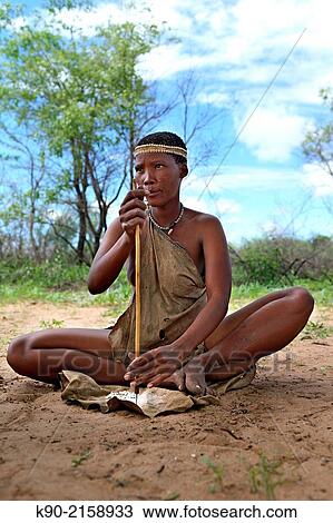 San woman drilling holes in small pieces of Ostrich eggs to form a necklace, Kalahari desert, Namibia, Africa. View Large Photo Image Stock Image - San woman drilling holes in small pieces of Ostrich eggs to form a necklace, Kalahari desert, Namibia, Africa.. Fotosearch