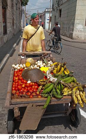 Stock Photo - Sancti Spiritus Cuba street scene of man with cart selling fruit. Fotosearch