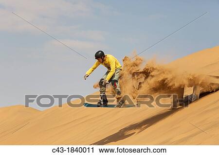 Sand boarding in the dunes of the Namib Desert near the coastal town of Swakopmund has become very popular Swakopmund, Namibia View Large Photo Image Stock Image - Sand boarding in the dunes of the Namib Desert near the coastal town of Swakopmund has become very popular Swakopmund, Namibia. Fotosearch