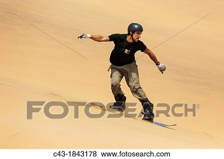 Sand boarding in the dunes of the Namib Desert near the coastal town of Swakopmund has become very popular Swakopmund, Namibia View Large Photo Image Stock Photo - Sand boarding in the dunes of the Namib Desert near the coastal town of Swakopmund has become very popular Swakopmund, Namibia. Fotosearch