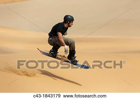 Sand boarding in the dunes of the Namib Desert near the coastal town of Swakopmund has become very popular Swakopmund, Namibia View Large Photo Image Stock Photo - Sand boarding in the dunes of the Namib Desert near the coastal town of Swakopmund has become very popular Swakopmund, Namibia. Fotosearch