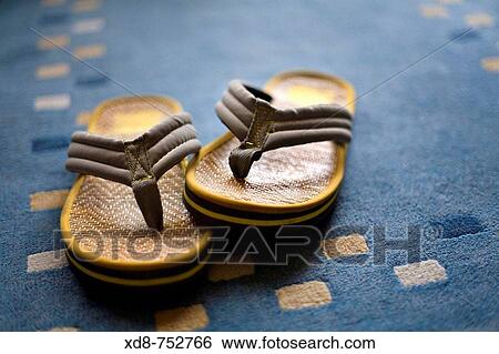Sandal pair over a carpet View Large Photo Image Stock Photograph - Sandal pair over a carpet. Fotosearch