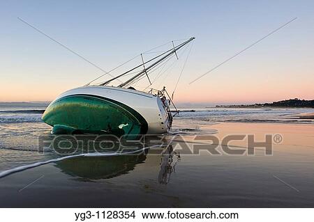 Santa Barbara, California: Sailboat washed ashore on beach during winter storm View Large Photo Image Picture - Santa Barbara, California: Sailboat washed ashore on beach during winter storm. Fotosearch