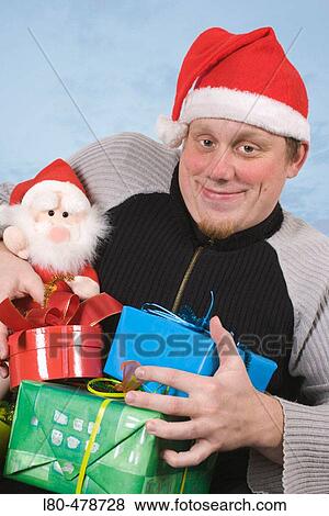 Santa Claus holding parcels View Large Photo Image Stock Photo - Santa Claus holding parcels. Fotosearch