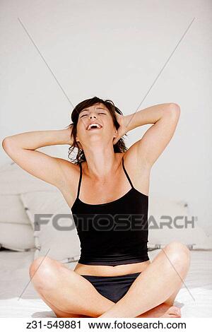 Santhi, Sitting, Legs crossed, Grinning View Large Photo Image Stock Image - Santhi, Sitting, Legs crossed, Grinning. Fotosearch