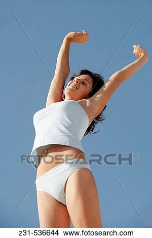Picture - Santhi, Underwear, Raise arms, Standing, Smiling, View from below. Fotosearch