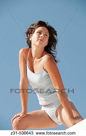 Stock Image - Santhi, Underwear, Stretching, Sexy, Smiling, View from below. Fotosearch