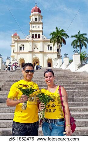 Santiago Cuba famous church called Basilica El Cabre with couple with flowers steeple and green grass on sunny day most important Cuban church View Large Photo Image Stock Photograph - Santiago Cuba famous church called Basilica El Cabre with couple with flowers steeple and green grass on sunny day most important Cuban church. Fotosearch
