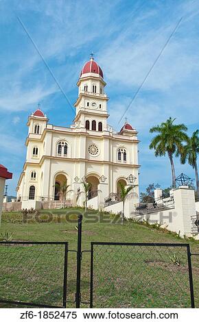 Stock Photography - Santiago Cuba famous church called Basilica El Cabre with steeple and green grass on sunny day most important Cuban church. Fotosearch