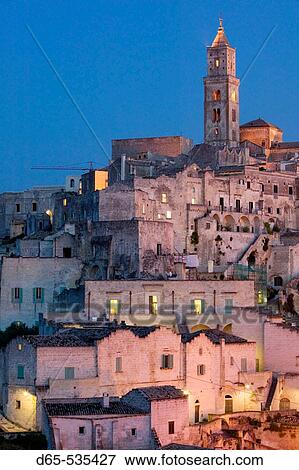 Stock Photo - Sasso Barisano: Sassi Houses & 13th century Duomo in the evening, Matera. Basilicata, Italy. Fotosearch