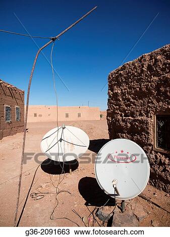 Satellite dish between buildings in village of Khamlia, Morrocco. View Large Photo Image Stock Image - Satellite dish between buildings in village of Khamlia, Morrocco.. Fotosearch