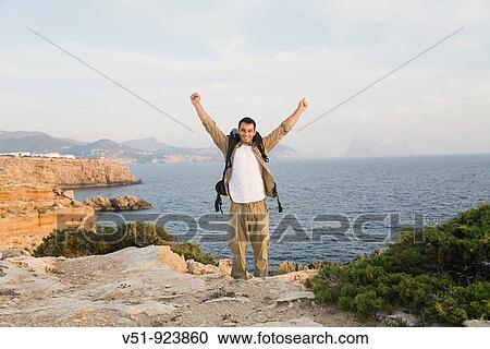 Satisfied man reaching the top View Large Photo Image Stock Image - Satisfied man reaching the top. Fotosearch