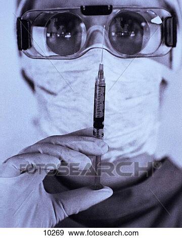 Stock Photo - Scary doc with needle. Fotosearch
