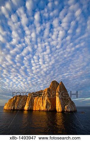 Stock Photo - Scenic view of Leon Dormido Sleeping Lion Island off San Cristobal Island in the Galapagos Island Archipelago, Ecuador MORE INFO This small island is a popular SCUBA diving site known for sharks, turtles and rays. Fotosearch