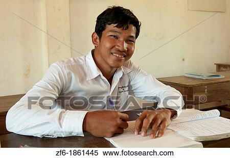 Stock Photography - School boy in school grade 8 work with book near Siem Reap In Cambodia Asia. Fotosearch