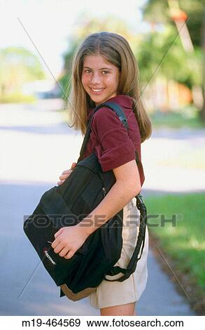 Stock Photo - school girl with a book bag. Fotosearch