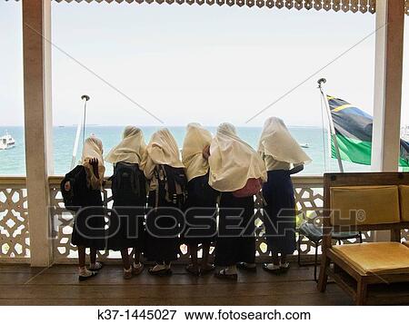 Stock Photo - School girls looking at view from Palace Museum, Stone Town, Zanzibar. Fotosearch