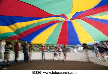 School kids playing games with a parachute View Large Photo Image Stock Photograph - School kids playing games with a parachute. Fotosearch