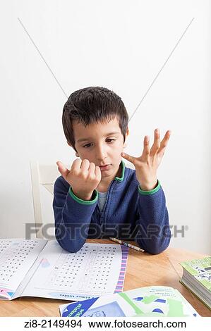 Picture - Schoolboy learning to count.. Fotosearch