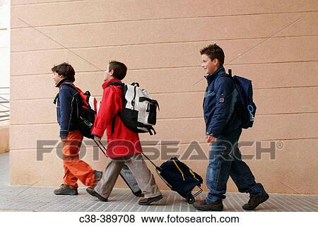 Schoolboys Carrying Their School Bags View Large Photo Image Stock Photo - Schoolboys Carrying Their School Bags. Fotosearch