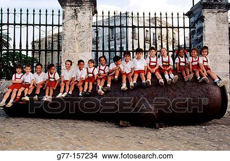 Schoolchildren on gun. Plaza de Armas. Havana. Cuba View Large Photo Image Picture - Schoolchildren on gun. Plaza de Armas. Havana. Cuba. Fotosearch