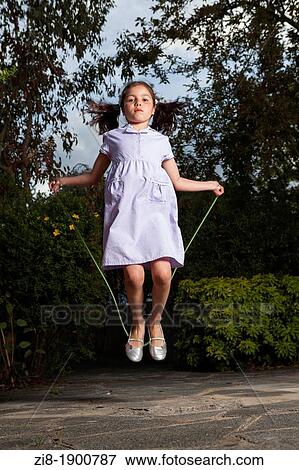 Schoolgirl jumping with a skipping rope View Large Photo Image Stock Photo - Schoolgirl jumping with a skipping rope. Fotosearch