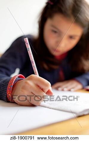Schoolgirl writes an essay-selective focus View Large Photo Image Stock Image - Schoolgirl writes an essay-selective focus. Fotosearch