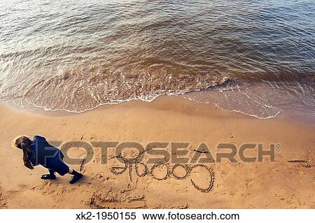 Schoolgirl writing GOOGLE in the sand View Large Photo Image Stock Photography - Schoolgirl writing GOOGLE in the sand. Fotosearch