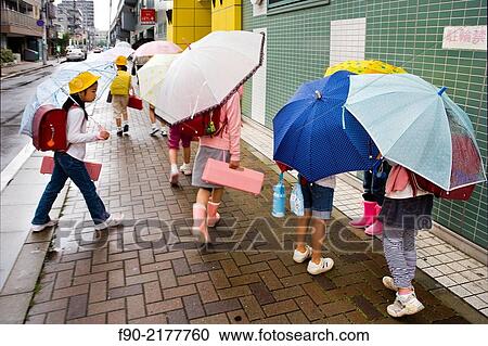 Schoolgirls with umbrellas in Tokyo, Japan. View Large Photo Image Stock Image - Schoolgirls with umbrellas in Tokyo, Japan.. Fotosearch