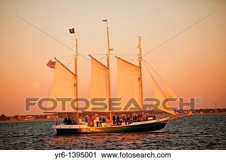 Stock Image - Schooner Pride sunset cruise of the harbor in Charleston, SC. Fotosearch
