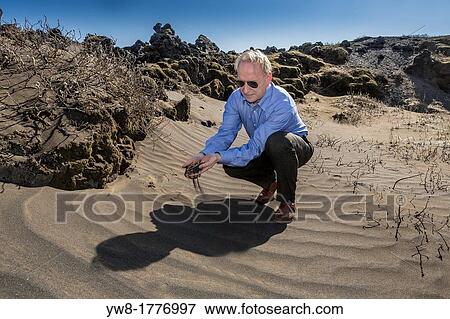 Scientist investigating ash from past volcanic eruptions, South Coast, Iceland View Large Photo Image Stock Photo - Scientist investigating ash from past volcanic eruptions, South Coast, Iceland. Fotosearch