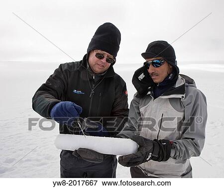 Stock Photo - Scientist with ice core samples doing glacial research on Vatnajokul Ice Cap, Iceland.. Fotosearch
