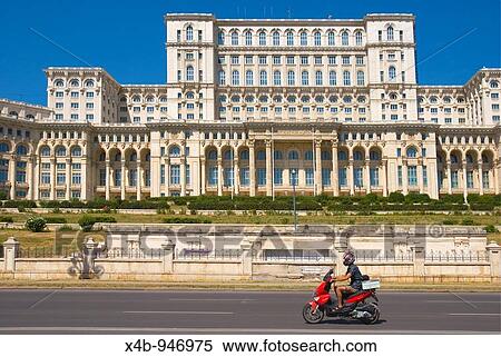Stock Photography - Scooter passing Palace of Parliament building in Bucharest Romania Europe. Fotosearch