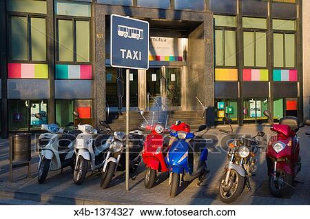 Stock Photo - Scooters parked at taxi rank along Gran Via de les Corts Catalanes street Barcelona Catalunya Spain Europe. Fotosearch