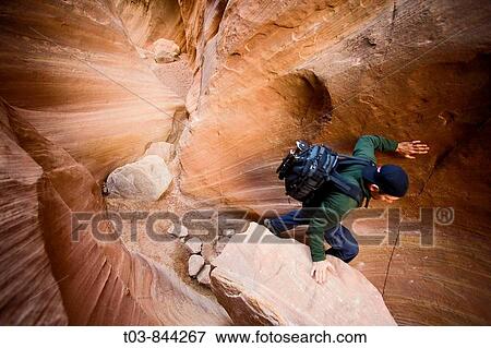 Scott Blatt scrambles over a low chokestone in Ding Canyon in the San Rafael Swell near Goblin Valley State Park in Utah View Large Photo Image Stock Photo - Scott Blatt scrambles over a low chokestone in Ding Canyon in the San Rafael Swell near Goblin Valley State Park in Utah. Fotosearch
