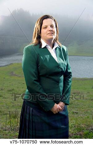 Stock Image - Scottish girl on a foggy Scottish landscape. Fotosearch