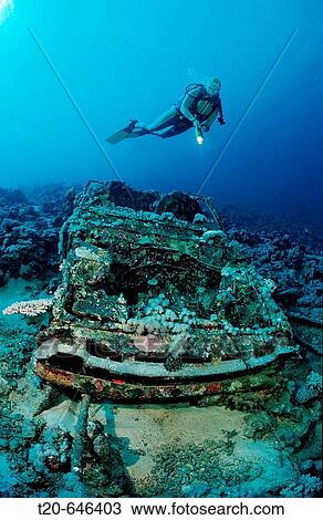 Stock Image - Scuba diver and Car wreck near Blue Belt shipwreck, Sudan, Africa, Red Sea. Fotosearch