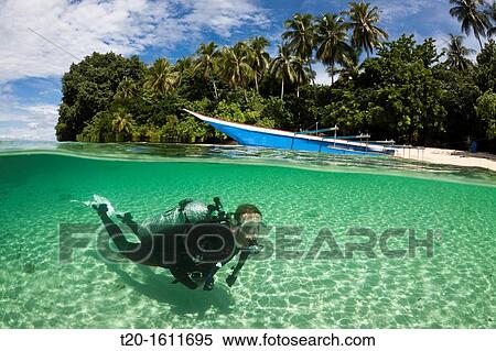 Scuba Diver in Lagoon of Ahe Island, Cenderawasih Bay, West Papua, Indonesia View Large Photo Image Stock Photography - Scuba Diver in Lagoon of Ahe Island, Cenderawasih Bay, West Papua, Indonesia. Fotosearch