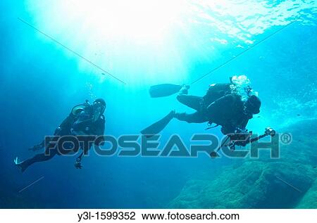 Scuba divers exploring La Gabiniere dive spot, Port-Cros, France underwater view View Large Photo Image Stock Image - Scuba divers exploring La Gabiniere dive spot, Port-Cros, France underwater view. Fotosearch