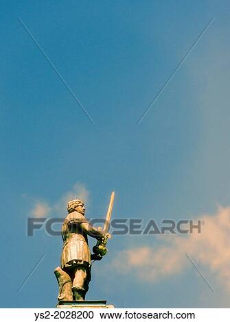 Stock Image - Sculpture of male warrior holding a sword in Stockholm, Sweden.. Fotosearch