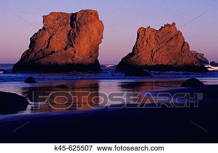 Stock Photo - Sea stacks on the beach at Bandon in early morning light, Southern Oregon coast, USA. Fotosearch