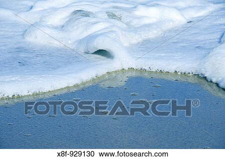 Seafoam in blue water View Large Photo Image Stock Image - Seafoam in blue water. Fotosearch