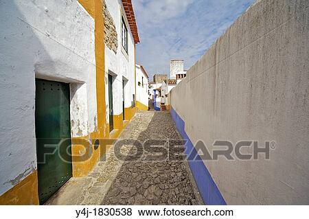 Secluded Cobblestone Street in the Medieval Village of Obidos View Large Photo Image Stock Photo - Secluded Cobblestone Street in the Medieval Village of Obidos. Fotosearch