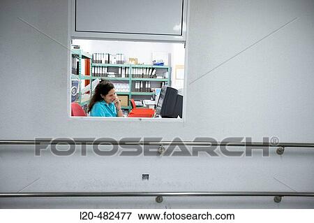Stock Photo - Secretary at maintenance office. Hospital Universitario Gran Canaria Doctor Negrin, Las Palmas de Gran Canaria. Canary Islands, Spain. Fotosearch